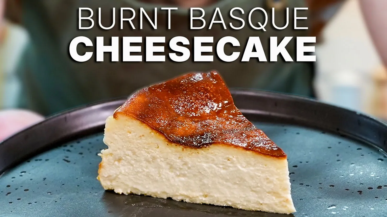 Slice of Burnt Basque Cheesecake with a caramelized top on a black plate. Text above reads "Burnt Basque Cheesecake."