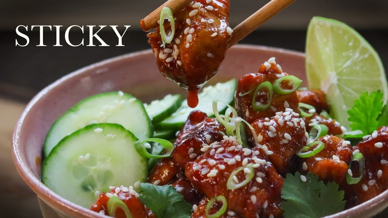 Sticky honey garlic chicken bowls, a still from its video, with the channel name and the recipe title in text across it