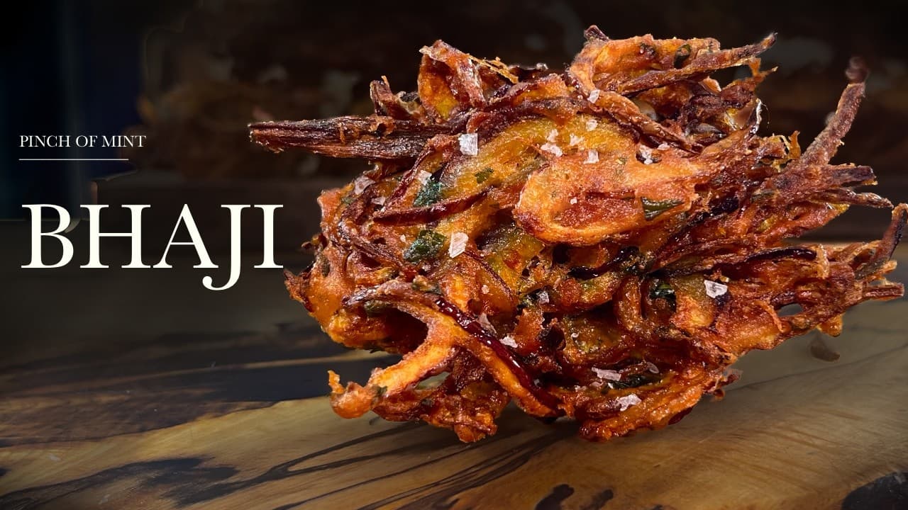 Crispy onion bhajis, a still from its video, with the channel name and the recipe title in text across it