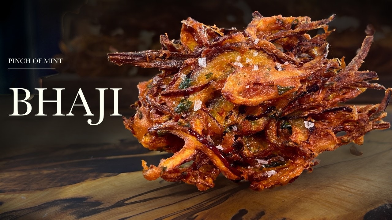 Crispy onion bhajis, a still from its video, with the channel name and the recipe title in text across it