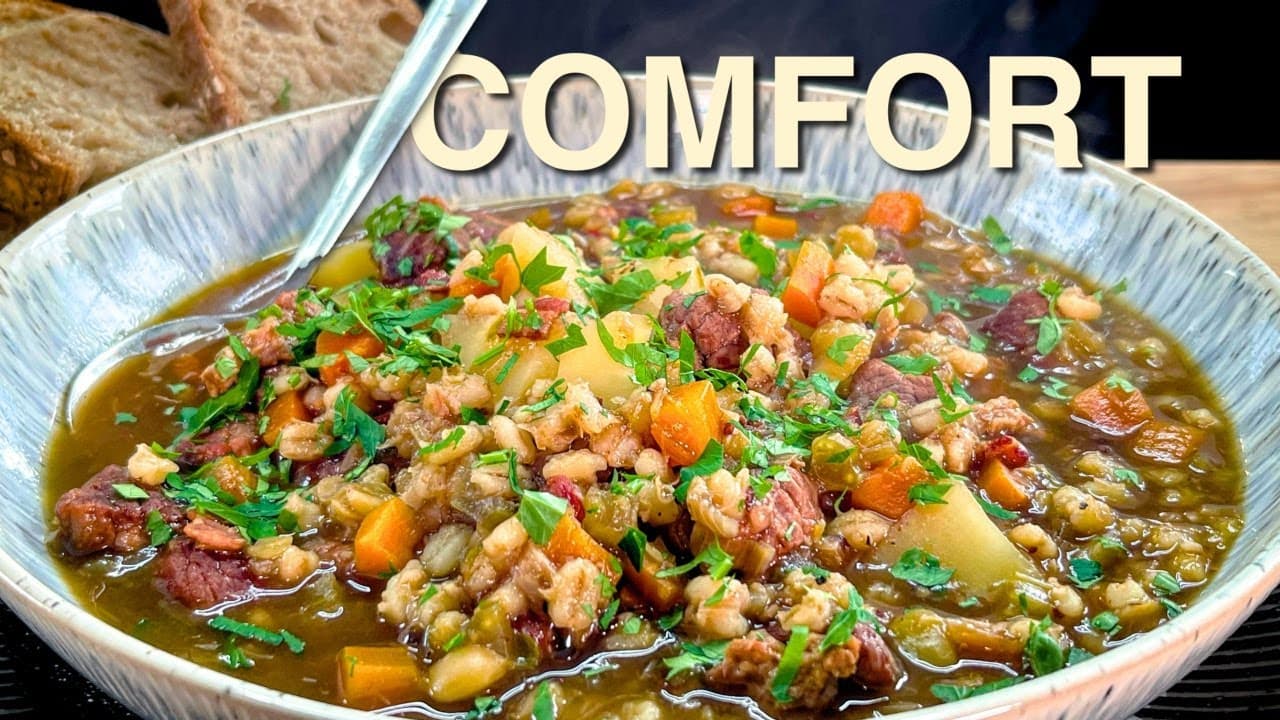 Beef and barley soup, a still from its video, with the channel name and the recipe title in text across it