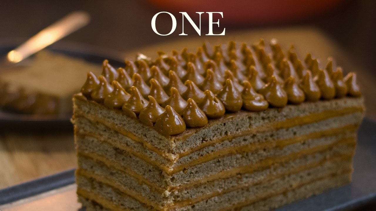 Coffee caramel layer cake, a still from its video, with the channel name and the recipe title in text across it